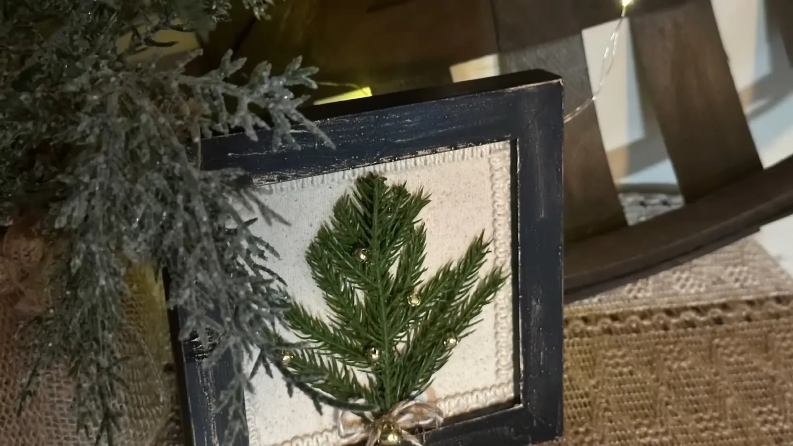 Finished miniature rustic evergreen tree decoration inside a picture frame