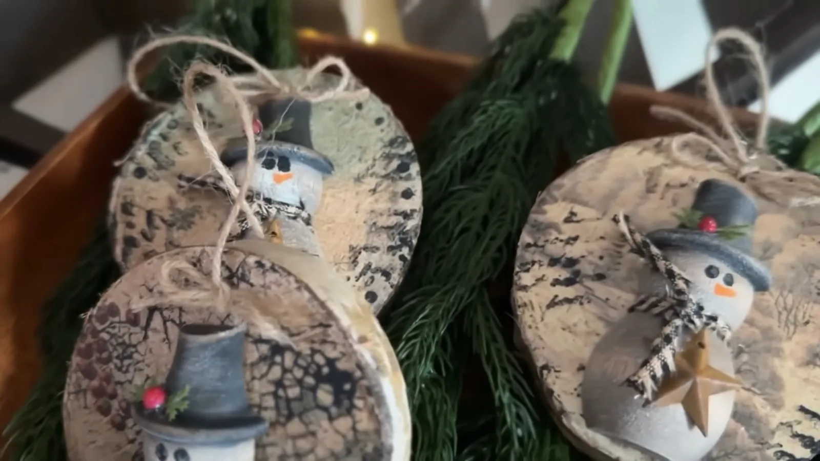Completed handmade primitive-style snowman ornaments for rustic Christmas decorating